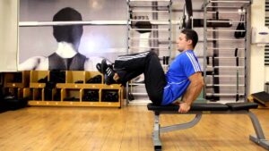 Seated Flat Bench Leg Pull In – Abs Exercise
